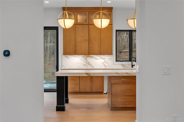 4627 Cimarron Dr, Bloomfield Hills, MI 48302 - kitchen with light wood finished floors, hanging light fixtures, light countertops, recessed lighting, and brown cabinets