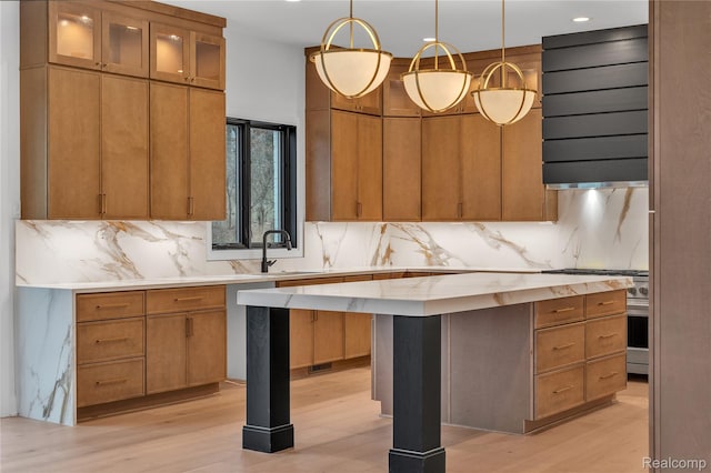 4627 Cimarron Dr, Bloomfield Hills, MI 48302 - kitchen featuring ventilation hood, tasteful backsplash, high end stove, light wood-type flooring, and recessed lighting