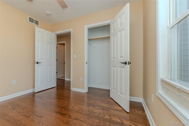 16017 Whippoorwill Ct, Manchester, MI 48158 - unfurnished bedroom with dark wood-style floors, a closet, and ceiling fan