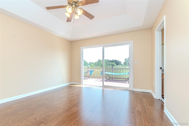 16017 Whippoorwill Ct, Manchester, MI 48158 - empty room featuring a raised ceiling, wood finished floors, and ceiling fan