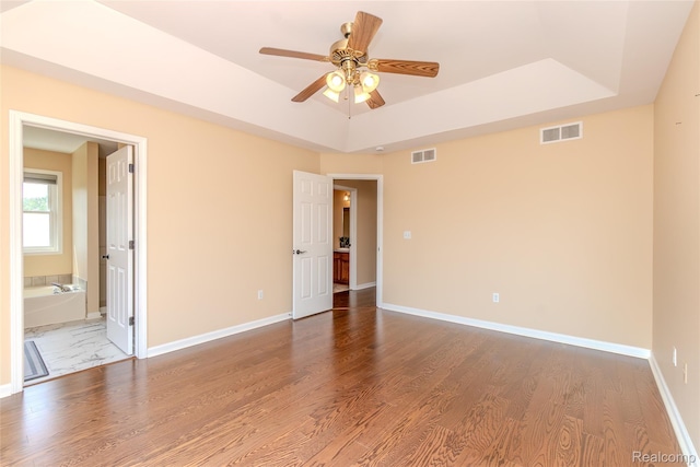 16017 Whippoorwill Ct, Manchester, MI 48158 - empty room with a tray ceiling, ceiling fan, and wood finished floors