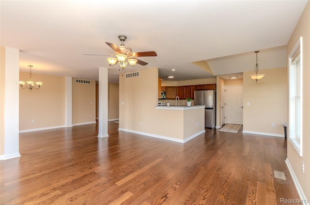 16017 Whippoorwill Ct, Manchester, MI 48158 - unfurnished living room featuring a ceiling fan, dark wood-style floors, a chandelier, and recessed lighting