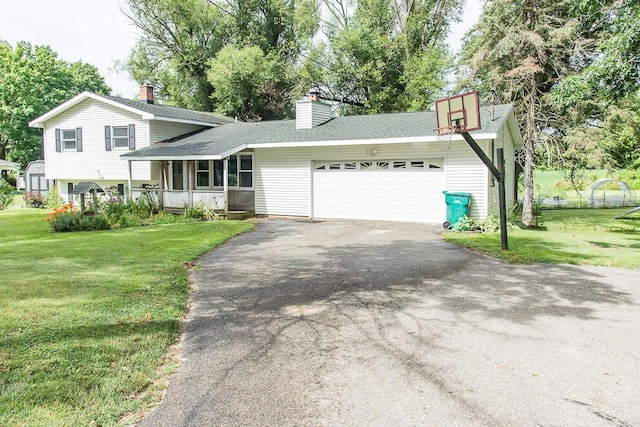 12345 Beadle Lake Rd, Battle Creek, MI 49014 - tri-level home featuring asphalt driveway, an attached garage, a front yard, and roof with shingles