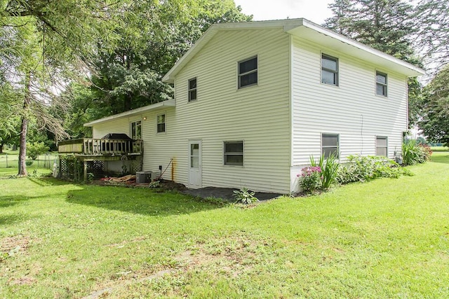 12345 Beadle Lake Rd, Battle Creek, MI 49014 - rear view of house featuring a lawn and a deck