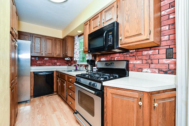 12345 Beadle Lake Rd, Battle Creek, MI 49014 - kitchen with black appliances, light countertops, light wood-style flooring, and backsplash