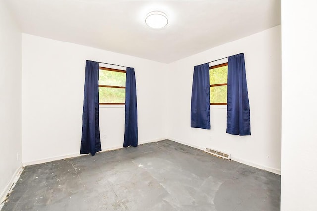 12345 Beadle Lake Rd, Battle Creek, MI 49014 - empty room featuring healthy amount of natural light and unfinished concrete flooring