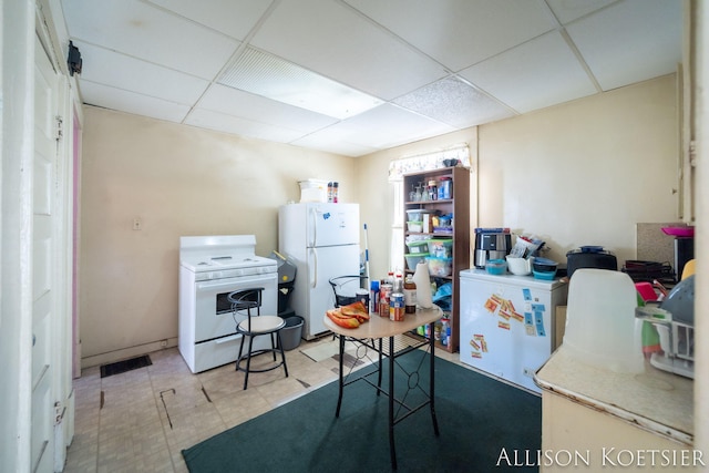 945 Kalamazoo Ave SE, Grand Rapids, MI 49507 - kitchen with white appliances and a paneled ceiling