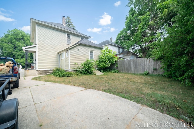 945 Kalamazoo Ave SE, Grand Rapids, MI 49507 - back of property with concrete driveway and a chimney