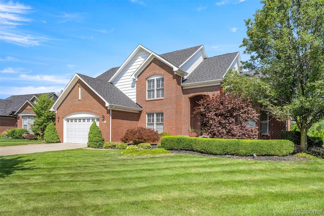 24065 Timber Creek Ln, Flat Rock, MI 48134 - traditional home with an attached garage, brick siding, a shingled roof, and a front yard