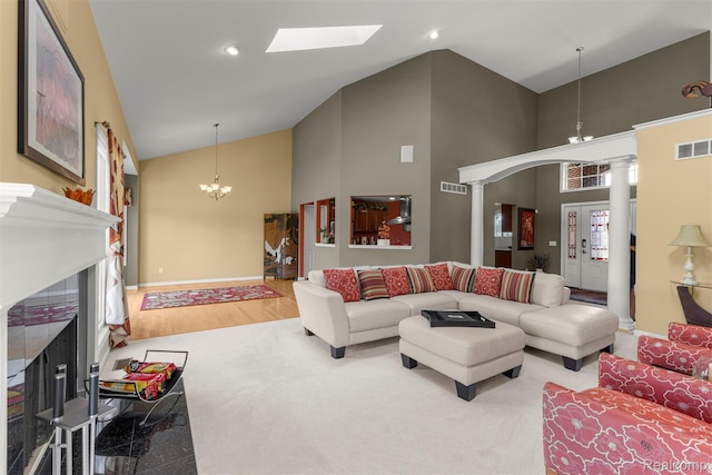 24065 Timber Creek Ln, Flat Rock, MI 48134 - living room featuring high vaulted ceiling, a fireplace with flush hearth, decorative columns, a chandelier, and recessed lighting