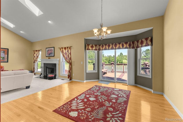 24065 Timber Creek Ln, Flat Rock, MI 48134 - living room featuring a chandelier, wood finished floors, healthy amount of natural light, a fireplace, and recessed lighting