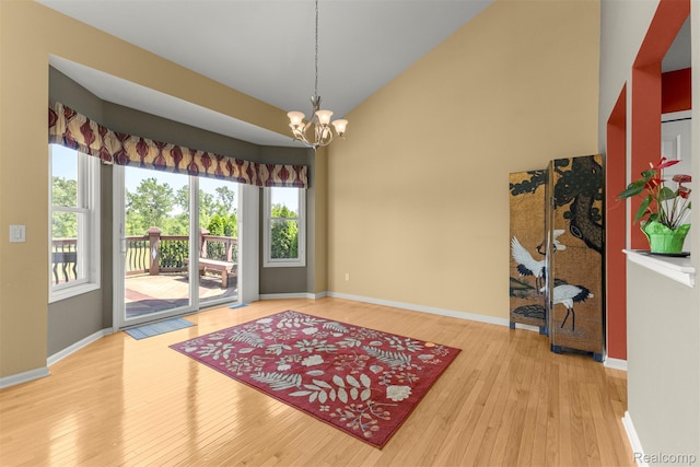 24065 Timber Creek Ln, Flat Rock, MI 48134 - unfurnished room featuring healthy amount of natural light, a chandelier, hardwood / wood-style floors, and high vaulted ceiling