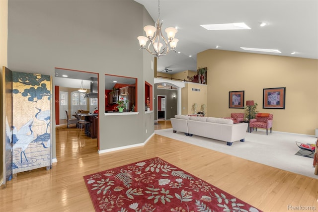 24065 Timber Creek Ln, Flat Rock, MI 48134 - living area with high vaulted ceiling, a chandelier, and wood finished floors