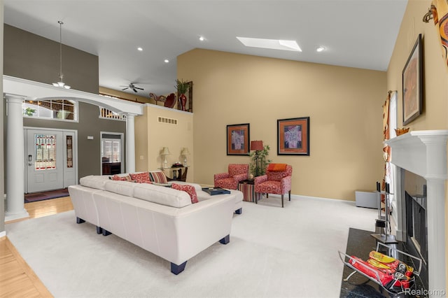 24065 Timber Creek Ln, Flat Rock, MI 48134 - living area featuring decorative columns, high vaulted ceiling, and a fireplace