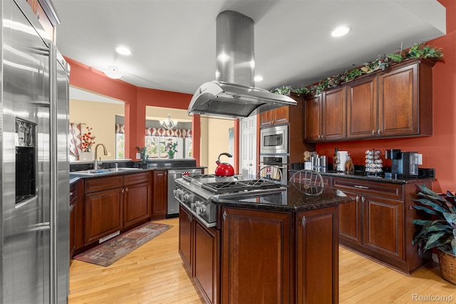 24065 Timber Creek Ln, Flat Rock, MI 48134 - kitchen featuring stainless steel appliances, island exhaust hood, light wood-type flooring, a kitchen island, and a chandelier