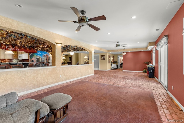 24065 Timber Creek Ln, Flat Rock, MI 48134 - living room featuring a ceiling fan, recessed lighting, and brick floors