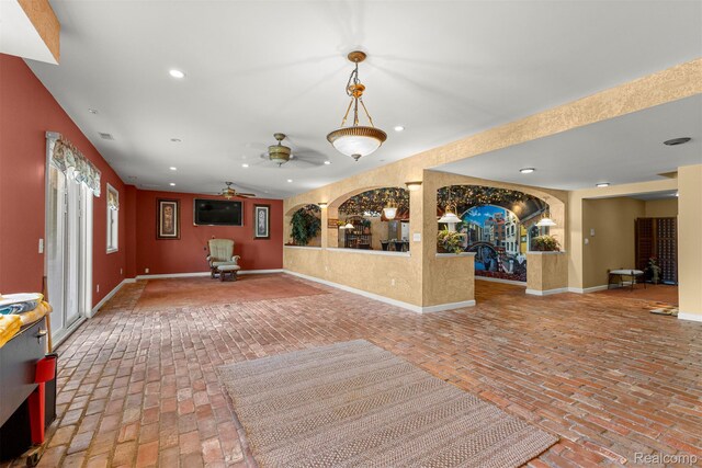 24065 Timber Creek Ln, Flat Rock, MI 48134 - unfurnished living room with brick floors, recessed lighting, and a ceiling fan