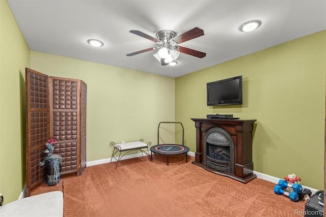 24065 Timber Creek Ln, Flat Rock, MI 48134 - sitting room with a fireplace, ceiling fan, and carpet flooring