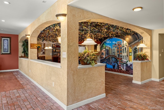 24065 Timber Creek Ln, Flat Rock, MI 48134 - corridor with brick flooring, recessed lighting, a textured wall, and arched walkways