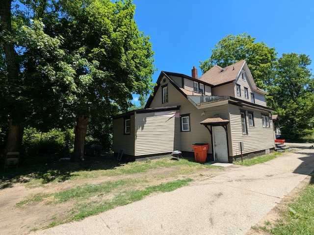 650 Pavone St, Benton Harbor, MI 49022 - view of home's exterior with a chimney