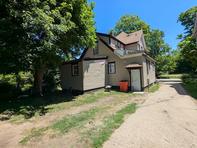 650 Pavone St, Benton Harbor, MI 49022 - view of front of property featuring driveway and a chimney