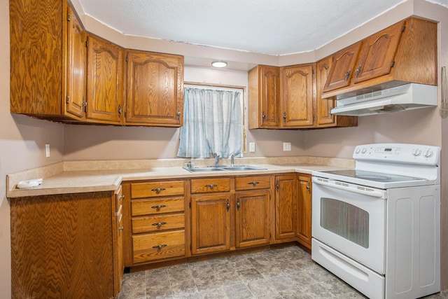 404 Susan Ave, Sturgis, MI 49091 - kitchen with electric range, under cabinet range hood, brown cabinetry, and light countertops