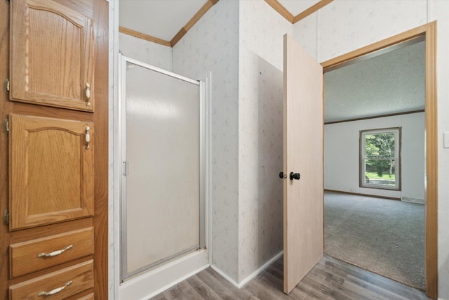 19905 N Ave, Battle Creek, MI 49017 - full bath with crown molding, wood finished floors, a shower stall, and wallpapered walls