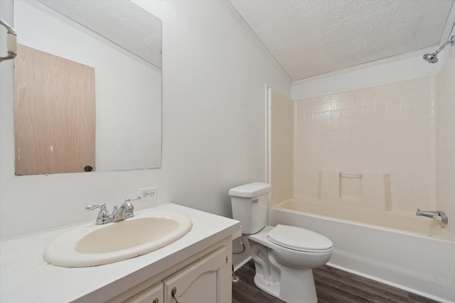 19905 N Ave, Battle Creek, MI 49017 - full bathroom with a textured ceiling, vanity, wood finished floors, and bathtub / shower combination