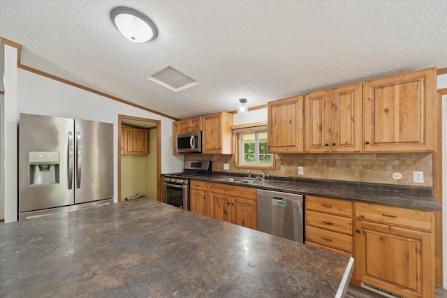19905 N Ave, Battle Creek, MI 49017 - kitchen with stainless steel appliances, dark countertops, vaulted ceiling, a textured ceiling, and decorative backsplash