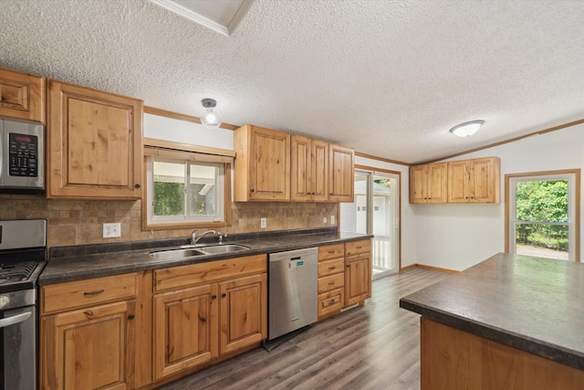 19905 N Ave, Battle Creek, MI 49017 - kitchen with stainless steel appliances, tasteful backsplash, dark countertops, healthy amount of natural light, and crown molding