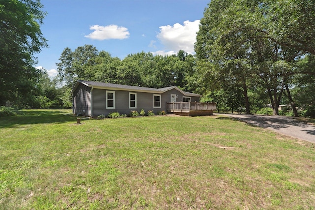 19905 N Ave, Battle Creek, MI 49017 - view of front of home featuring a wooden deck, a front lawn, and driveway