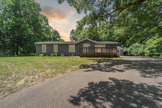 19905 N Ave, Battle Creek, MI 49017 - ranch-style home with a wooden deck, an outdoor structure, a front yard, driveway, and a garage