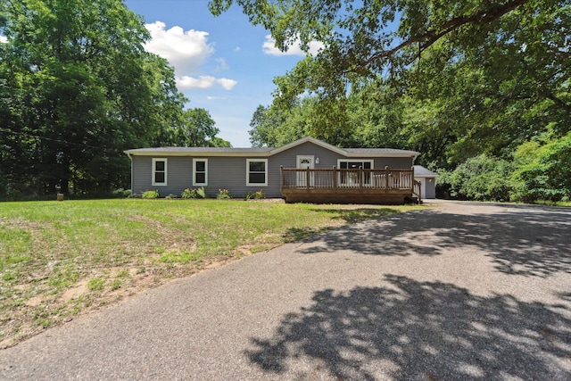 19905 N Ave, Battle Creek, MI 49017 - ranch-style home featuring an outbuilding, a deck, a front lawn, a garage, and asphalt driveway