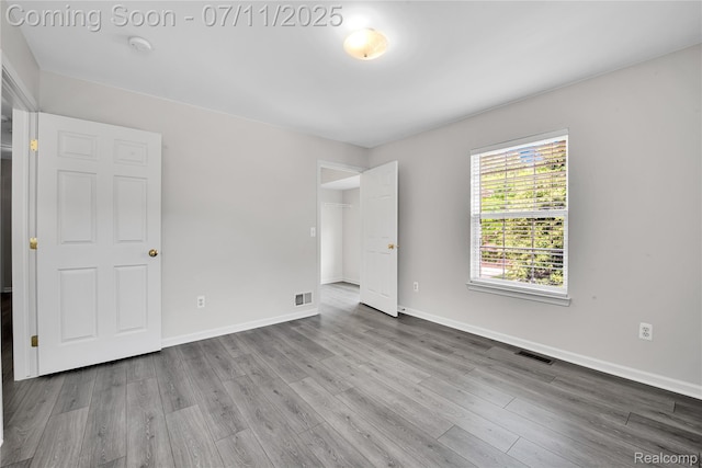 3454 Everett Dr, Rochester Hills, MI 48307 - unfurnished bedroom featuring wood finished floors and baseboards