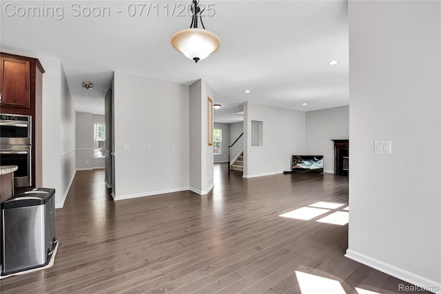 3454 Everett Dr, Rochester Hills, MI 48307 - unfurnished living room with stairway, dark wood-style floors, plenty of natural light, a glass covered fireplace, and recessed lighting