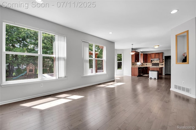 3454 Everett Dr, Rochester Hills, MI 48307 - unfurnished living room with healthy amount of natural light, recessed lighting, and dark wood-style flooring