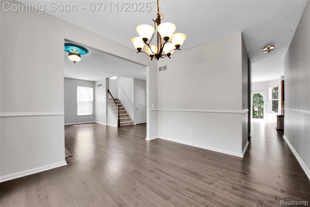 3454 Everett Dr, Rochester Hills, MI 48307 - empty room with healthy amount of natural light, a chandelier, wood finished floors, and stairway
