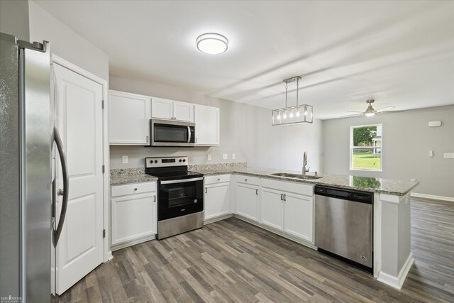180 Ash St, Corunna, MI 48817 - kitchen featuring stainless steel appliances, dark wood finished floors, white cabinetry, a peninsula, and light stone countertops