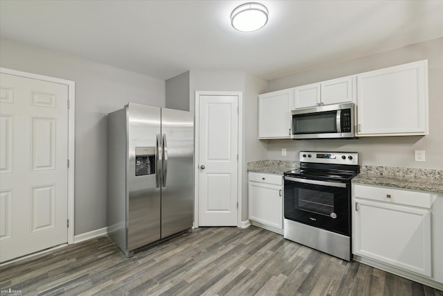 180 Ash St, Corunna, MI 48817 - kitchen featuring stainless steel appliances, dark wood finished floors, white cabinetry, and light stone countertops