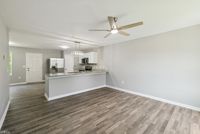 180 Ash St, Corunna, MI 48817 - kitchen featuring stainless steel appliances, a peninsula, dark wood-style flooring, and a ceiling fan