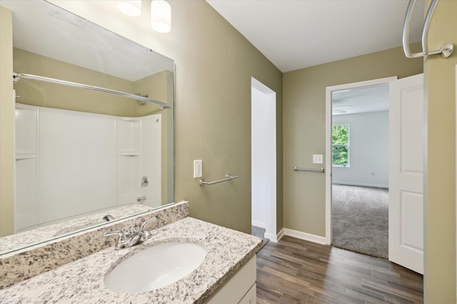 180 Ash St, Corunna, MI 48817 - full bathroom featuring wood finished floors, vanity, and shower / bath combination