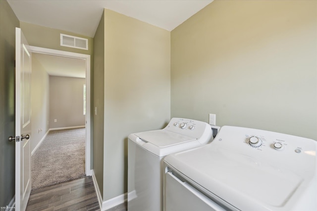 180 Ash St, Corunna, MI 48817 - laundry area with washing machine and dryer, dark wood-type flooring, and dark colored carpet