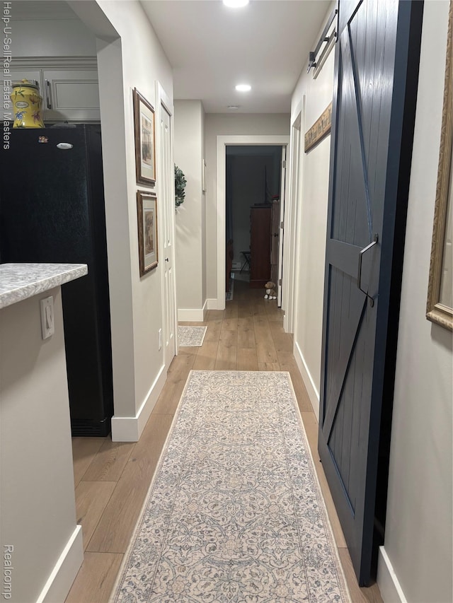 1975 Michigan Ave Unit 47, Marysville, MI 48040 - hallway featuring a barn door, light wood finished floors, and recessed lighting