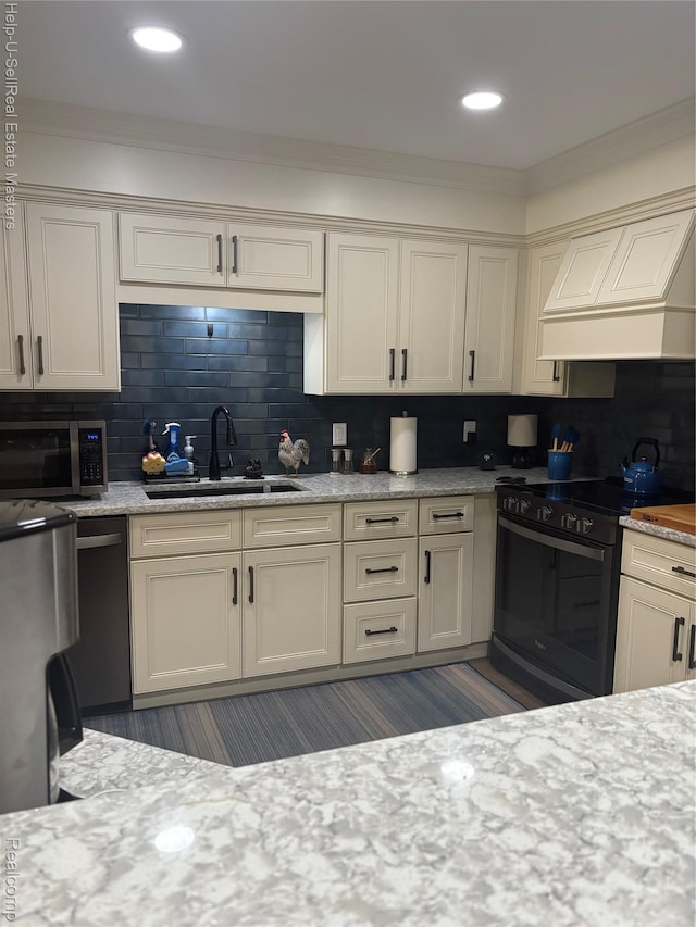 1975 Michigan Ave Unit 47, Marysville, MI 48040 - kitchen with stainless steel microwave, electric range, tasteful backsplash, custom range hood, and ornamental molding