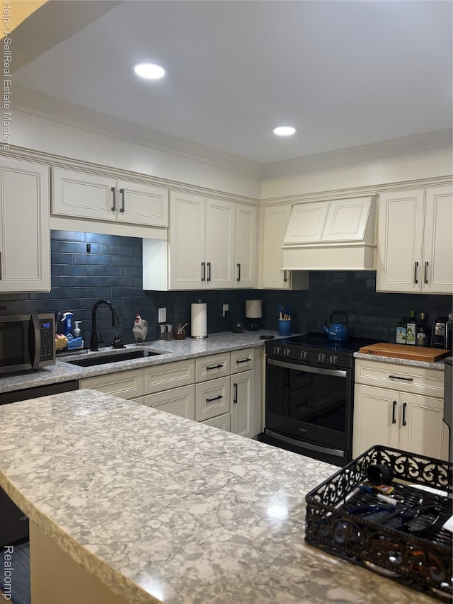 1975 Michigan Ave Unit 47, Marysville, MI 48040 - kitchen featuring range, custom range hood, stainless steel microwave, tasteful backsplash, and crown molding
