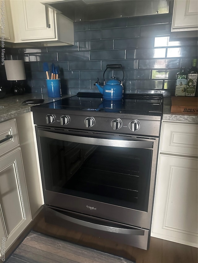 1975 Michigan Ave Unit 47, Marysville, MI 48040 - kitchen with stainless steel range, white cabinetry, and decorative backsplash