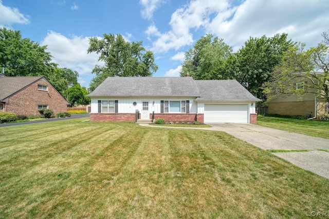 608 Brook St, Tecumseh, MI 49286 - view of front of house with brick siding, a garage, a front lawn, and concrete driveway
