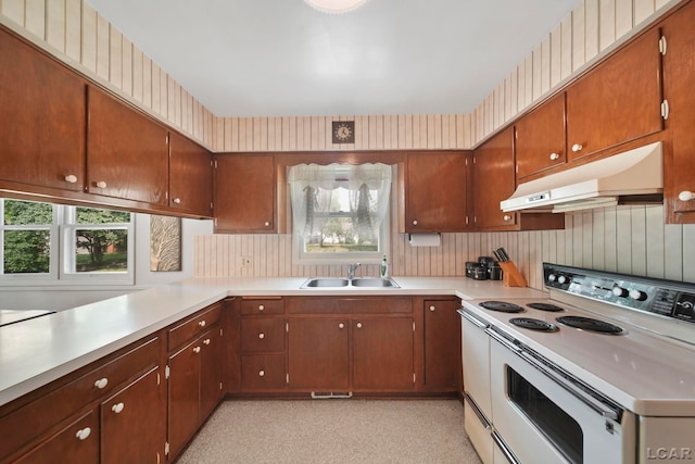 608 Brook St, Tecumseh, MI 49286 - kitchen featuring white range with electric cooktop, under cabinet range hood, light countertops, and healthy amount of natural light