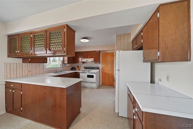 608 Brook St, Tecumseh, MI 49286 - kitchen featuring white appliances, under cabinet range hood, a peninsula, brown cabinetry, and light countertops