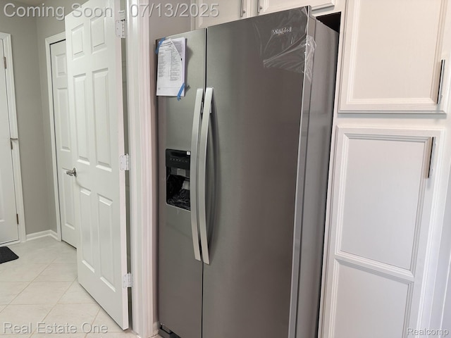 820 Woodhaven Dr, Commerce Twp, MI 48390 - kitchen featuring stainless steel refrigerator with ice dispenser, light tile patterned floors, and white cabinets